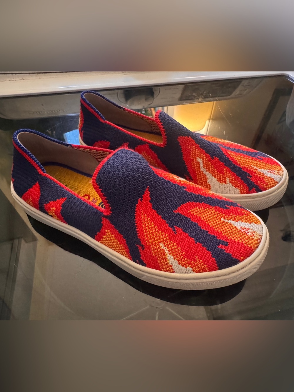 Kids Rothy’s slip on sneakers in Navy with Red and Orange Flame Pattern, size 2